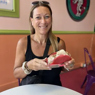 Rolled ice cream in a pink taco with whipped cream.  It comes with two toppings but I chose five.