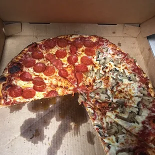 half of a pepperoni and mushroom pizza