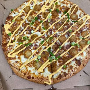 The LOADED TOT-ZZA - a tater tot and cheese pizza with smoked bacon and green onion. That's ranch dressing