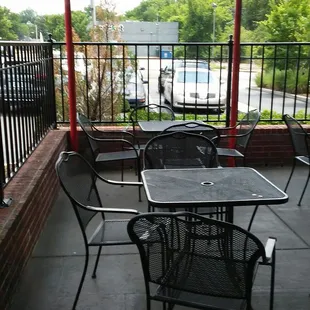 ows a patio with tables and chairs