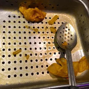 a colander with a scoop of food in it