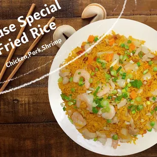 a plate of fried rice and chopsticks