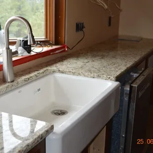 Granite Santa Cecelia on the cabinet bases - undercount Kohler Farm sink.