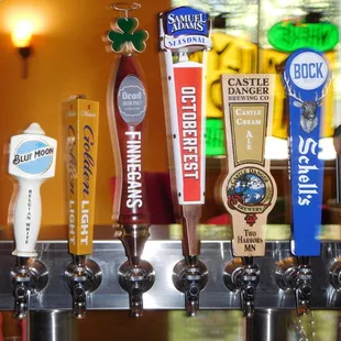 a row of beer taps