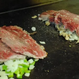 Our Original Philadelphia Cheesesteaks sizzling on the grill.
