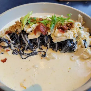 Squid ink pasta with crabmeat and prosciutto with cream sauce.