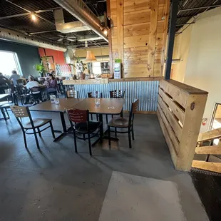 the inside of a restaurant with tables and chairs