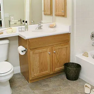 Apartment bathroom. Lots of cabinets for storage.