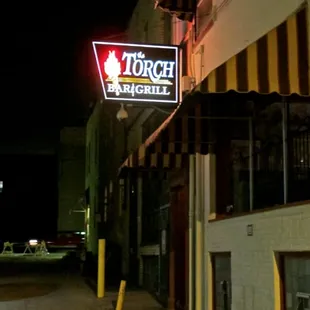 a neon sign on the side of a building