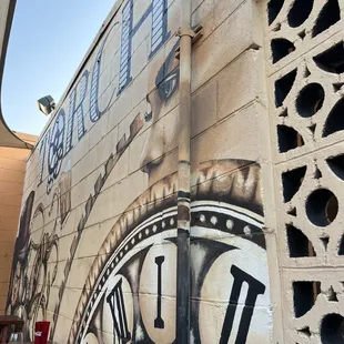 a clock painted on the side of a building