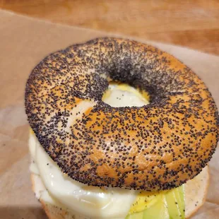 a bagel with cheese and avocado