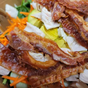 a salad with bacon and vegetables