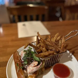 a basket of fries and a lobster sandwich