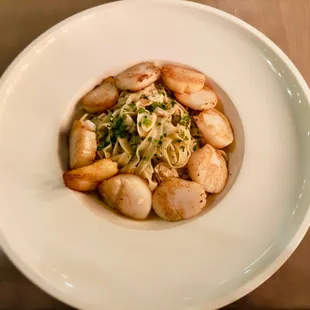 scallops and broccoli in a white bowl