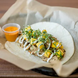 BRUSHFIRE - JAMAICAN JERK CHICKEN, GRILLED JALAPEÑOS, MANGO, SOUR CREAM &amp; CILANTRO WITH DIABLO SAUCE ON A FLOUR TORTILLA.