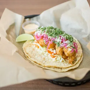 BAJA SHRIMP - FRIED SHRIMP, COOKED CABBAGE SLAW, PICKLED ONIONS &amp; JALAPEÑOS, COTIJA CHEESE, CILANTRO &amp; A LIME WEDGE WITH CHIPOTLE SAUCE.