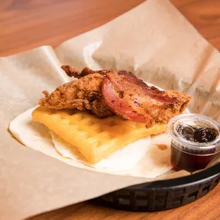 Roscoe - A flour tortilla with a crisp waffle, a fried egg, fried chicken, and a slice of bacon. Served with a side of maple syrup