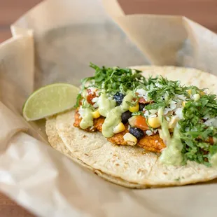 a taco with a lime wedge