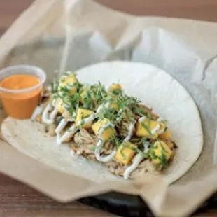 a chicken taco with mango salsa