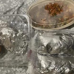 Steak street tacos, barbacoa and steak tacos and burrito bowl. Remote for size.