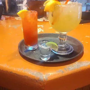 two cocktails on a bar