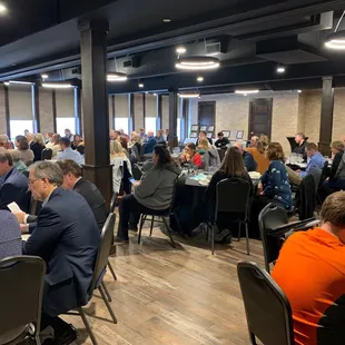 a large group of people sitting at tables