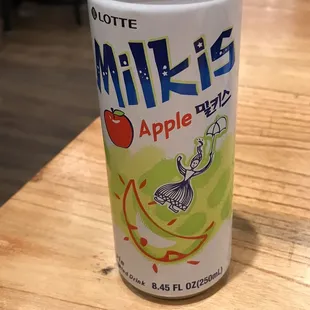 a can of apple juice on a table