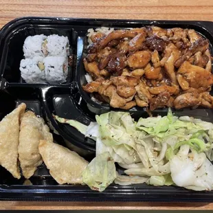 Chicken teriyaki bento box - chicken teriyaki, fried rice (also have white), 3 pieces sushi, pot stickers and cabbage