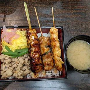 a plate of food with rice, meat, and vegetables