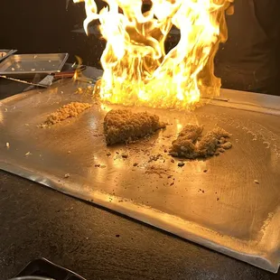 a person cooking food on a grill