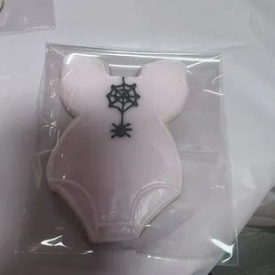 a pink bodysuit with a spider on it