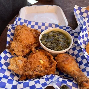 a basket of fried chicken with a side of green beans