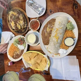 Loaded steak fajita and a grande grilled chicken burrito with two house margaritas!