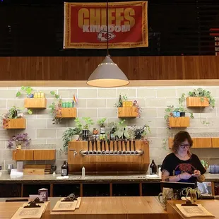 a woman standing at the bar