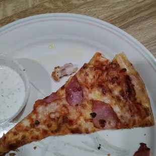 a half eaten slice of pizza