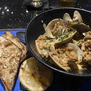Clans with grilled bread, chorizo herb garlic butter sauce.