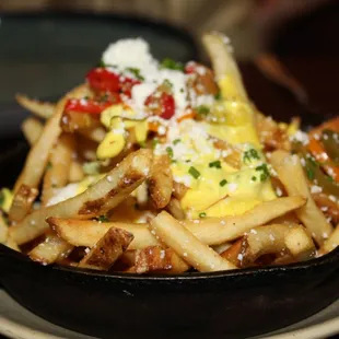 The Truffle Fries are made with cotija cheese, aji tartar &amp; pickled chiles.