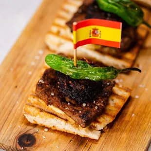 a plate of food with a spanish flag on top