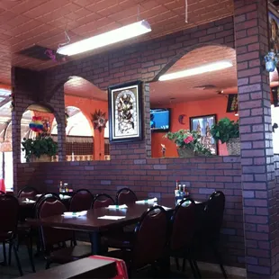 a dining room with a brick wall