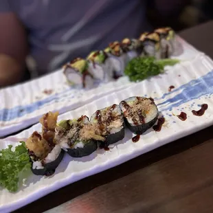 Half eaten spider roll and dragon roll
