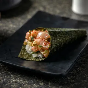 a sushi roll on a black plate