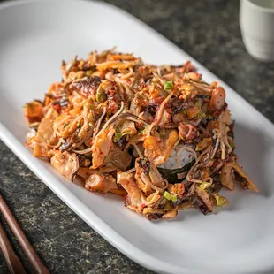 a plate of food with chopsticks