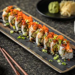 a plate of sushi and chopsticks