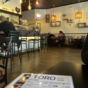 Restaurant remodel has tables and a bar to sit at to watch the sushi be made