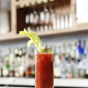 a bloody drink with celery garnish