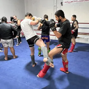 Practicing blocking leg kicks in the advance class.