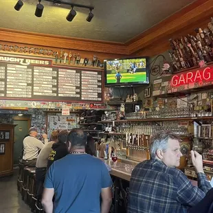 customers at a bar with a lot of liquor