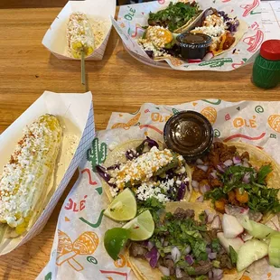 Street corn with fried avocado, asada and pastor street tacos