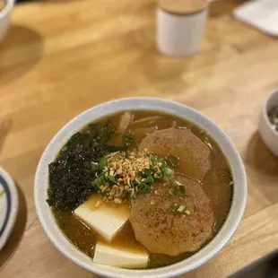 a bowl of ramen with tofu and broccoli