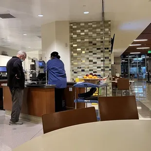 two people standing at the counter